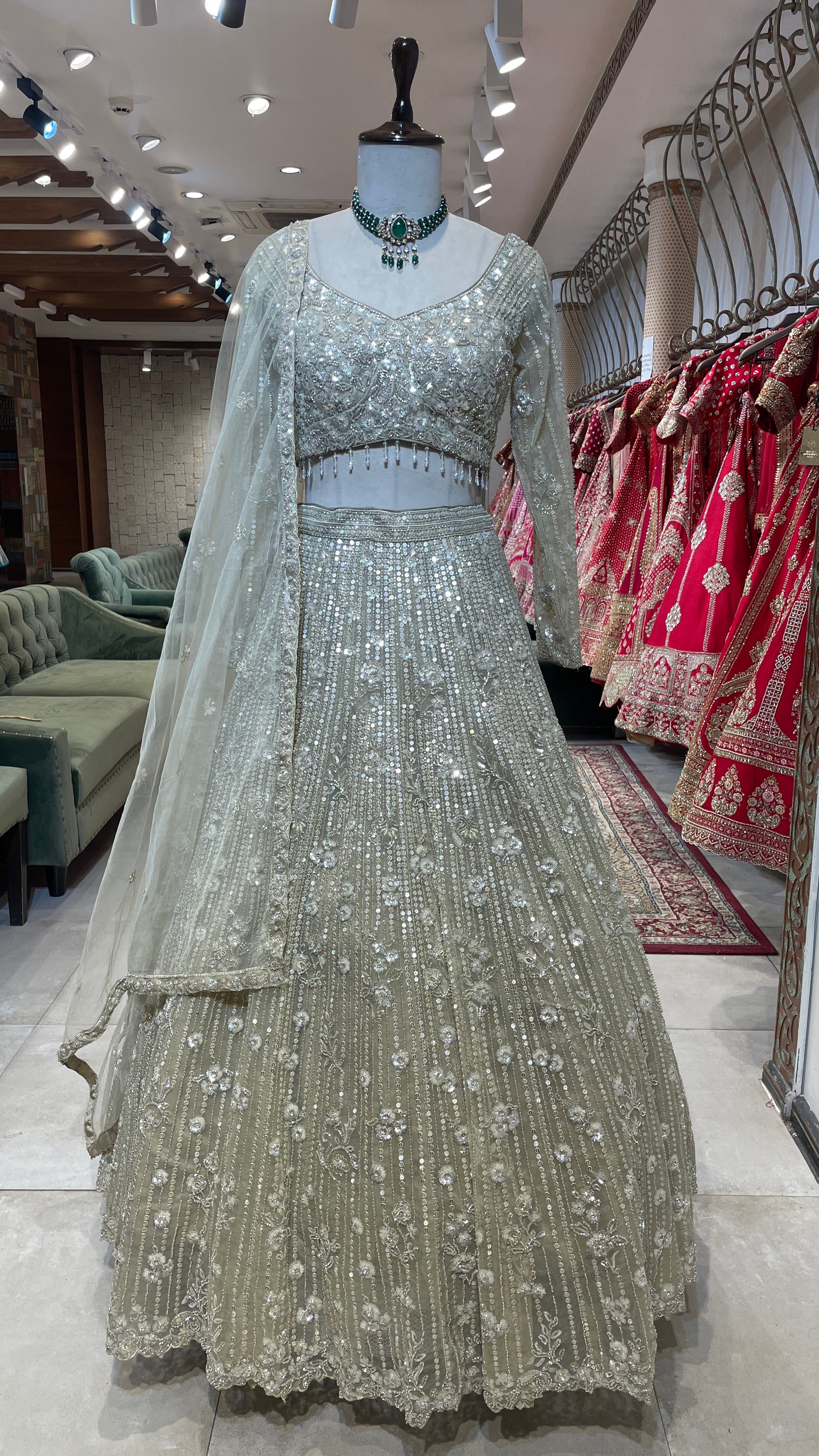 Cream net lehenga with cutdana and floral motifs