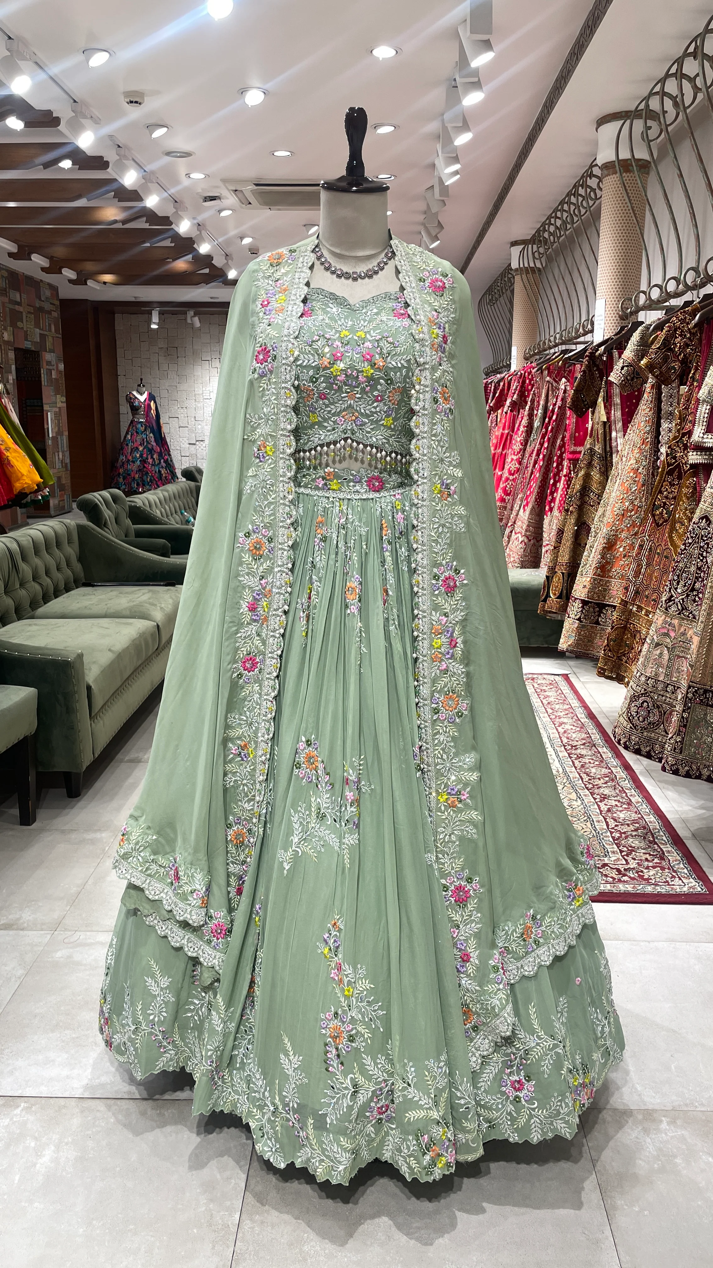 Pastel green Georgette lehenga with cape and floral motifs