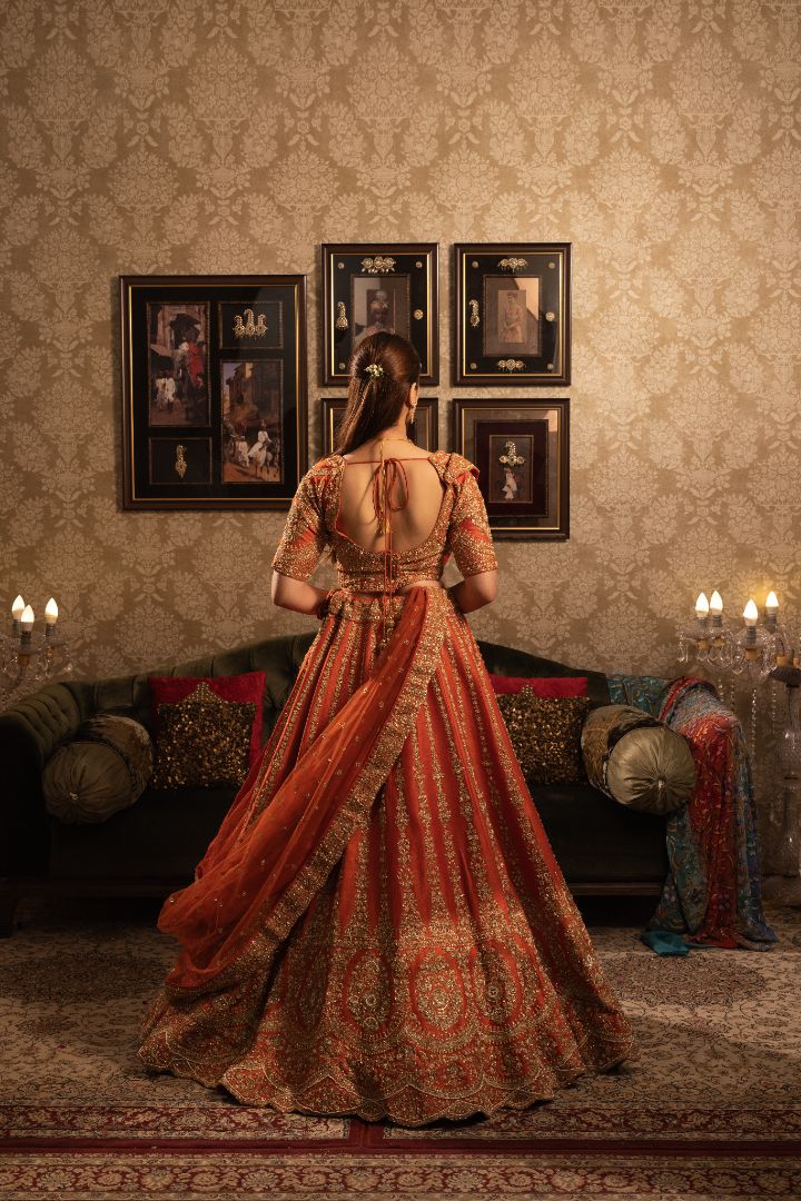 Rust Bridal Lehenga with Cutdana & Sequins Gold Embellishment and Double Dupatta - Image 2